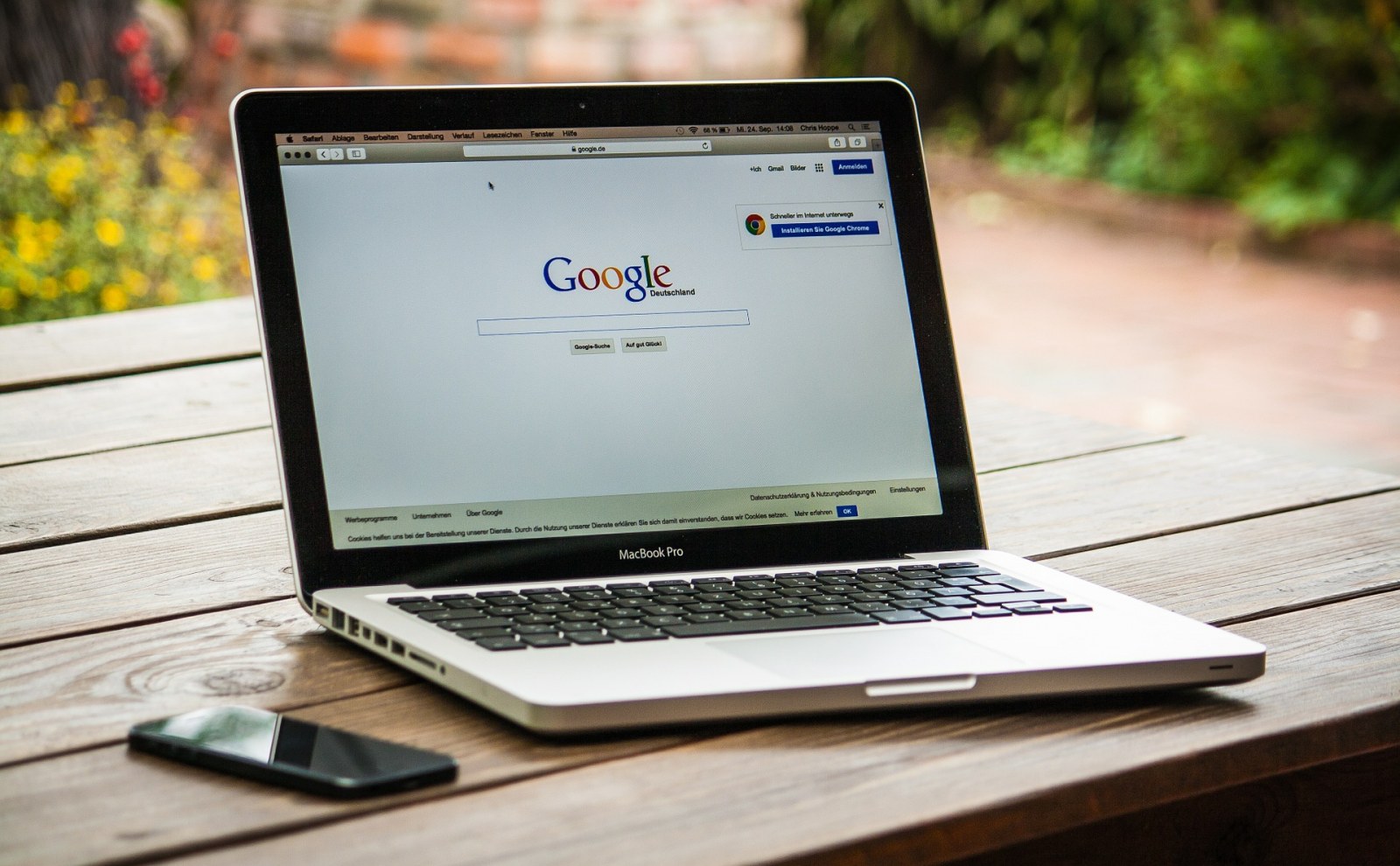 Laptop sitting on an outdoor table with google on the screen